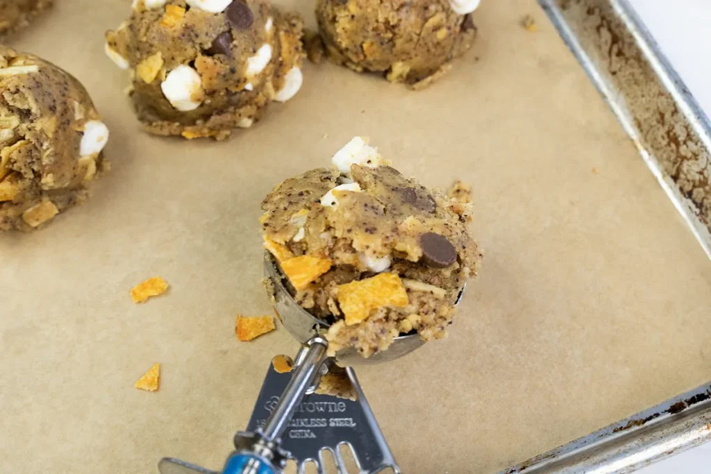 Scooping kitchen sink cookie dough.