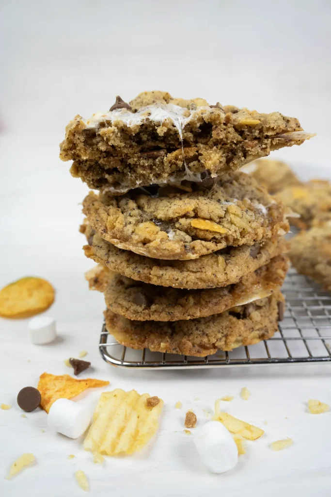 A stack of kitchen sink cookies on a cooling rack.