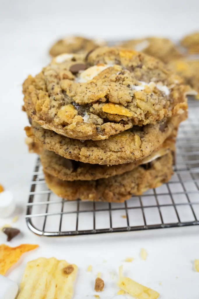 A stack of kitchen sink cookies on a cooling rack.