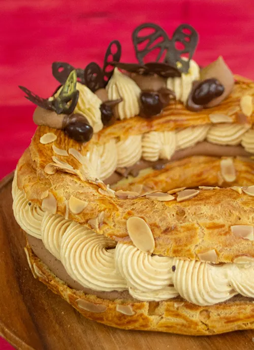 Paris-Brest pastry filled with creams and nuts and topped with chocolate butterflies.