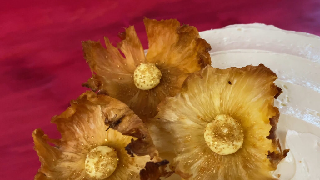 Pineapple flowers with a buttercream center decorated with metallic sprinkles.