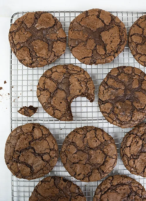 Chocolate orange brookie cookies on a cooling rack.