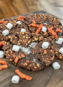 Flamin' Hot Cheetos Cookies in a pile with. marshmallows and Cheetos.