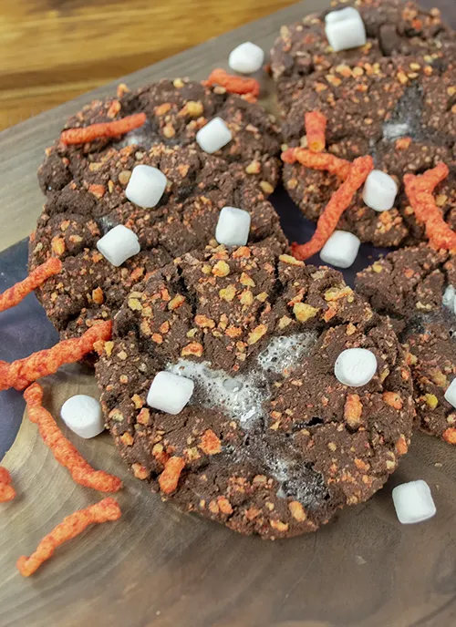 Flamin' Hot Cheetos Cookies in a pile with. marshmallows and Cheetos.