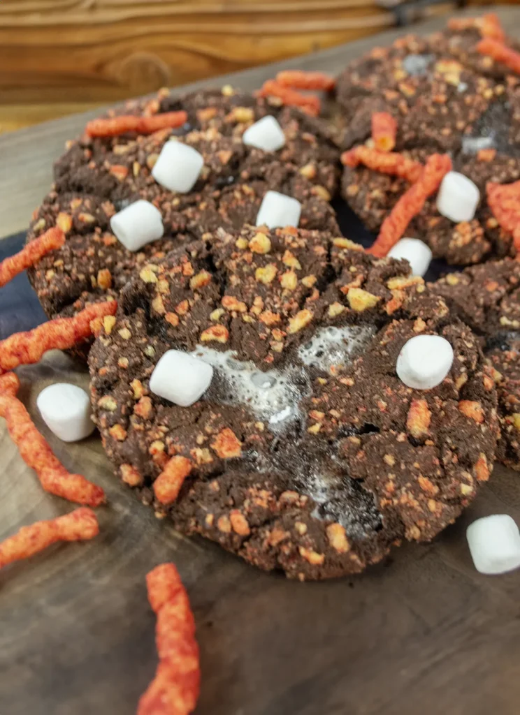 Flamin' Hot Cheetos cookies on a wooden board.