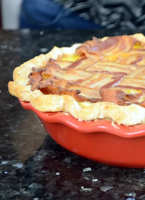 Deep dish breakfast pie with a bacon lattice top.
