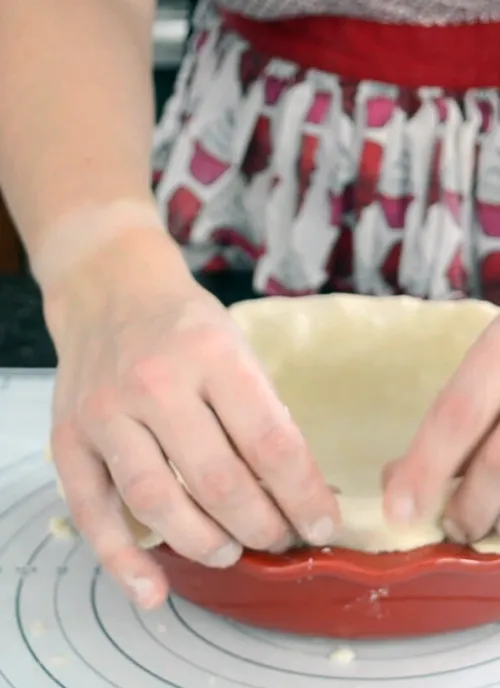 Crimping the edge of a pie crust.