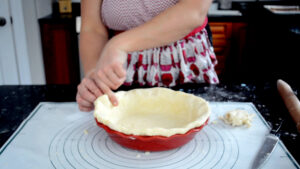 Crimping the edge of a pie crust.