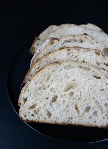 Slices of sourdough bread arranged on a plate.