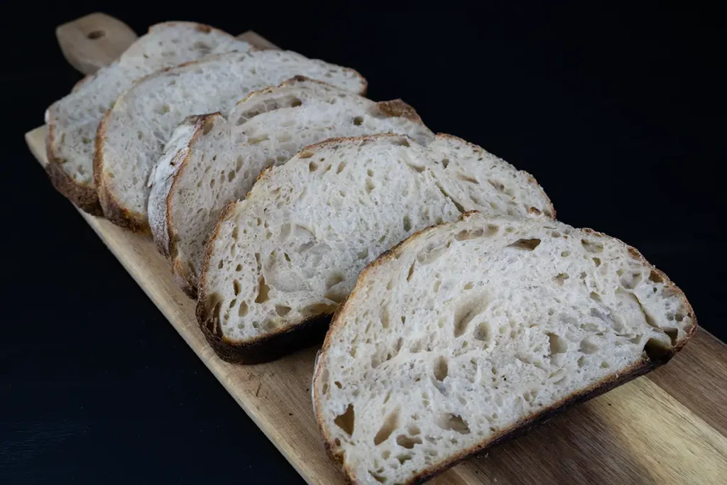 Slices of bread arranged on a wooden board.