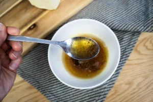A bowl of browned butter with a spoon.