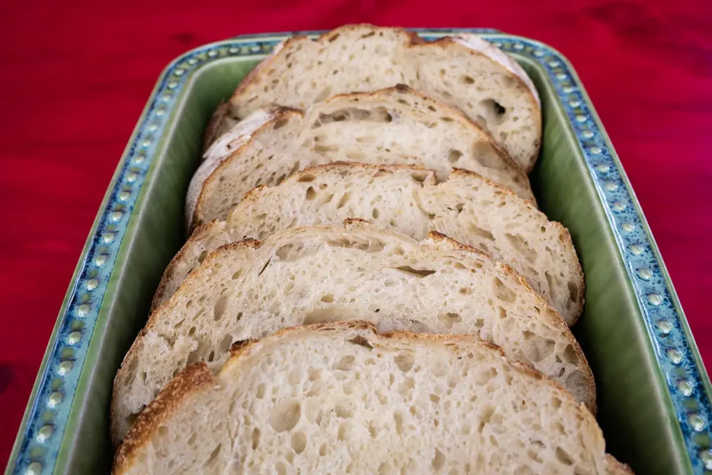 Slices of bread arranged in a ceramic baking dish.
