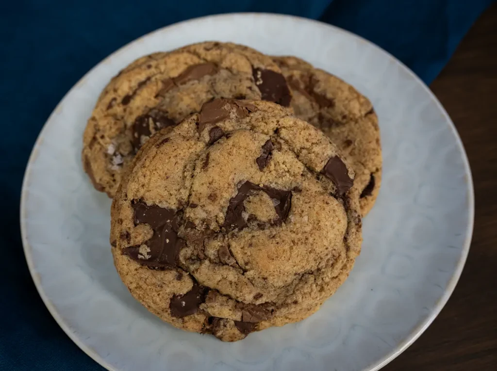 Sourdough chocolate chip cookies on a plate.