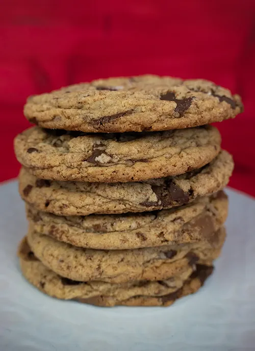 Stack of sourdough chocolate chip cookies on a plate.