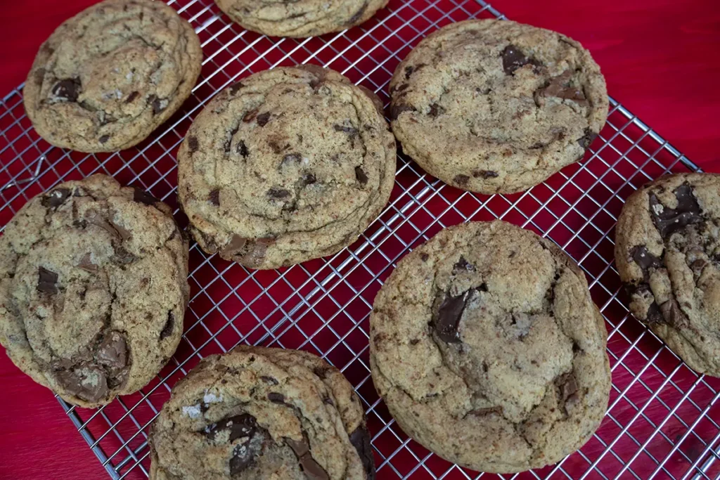 Sourdough chocolate chip cookies on a wire cooling rack.