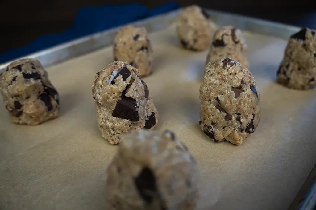 Sourdough chocolate chip cookie dough shaped like oblong towers before being baked.