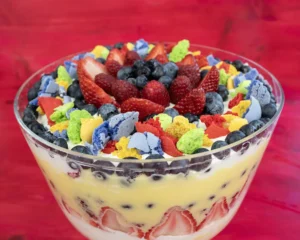 Fresh fruit trifle with macaron crumbles, fresh berries, lemon curd, and whipped cream.
