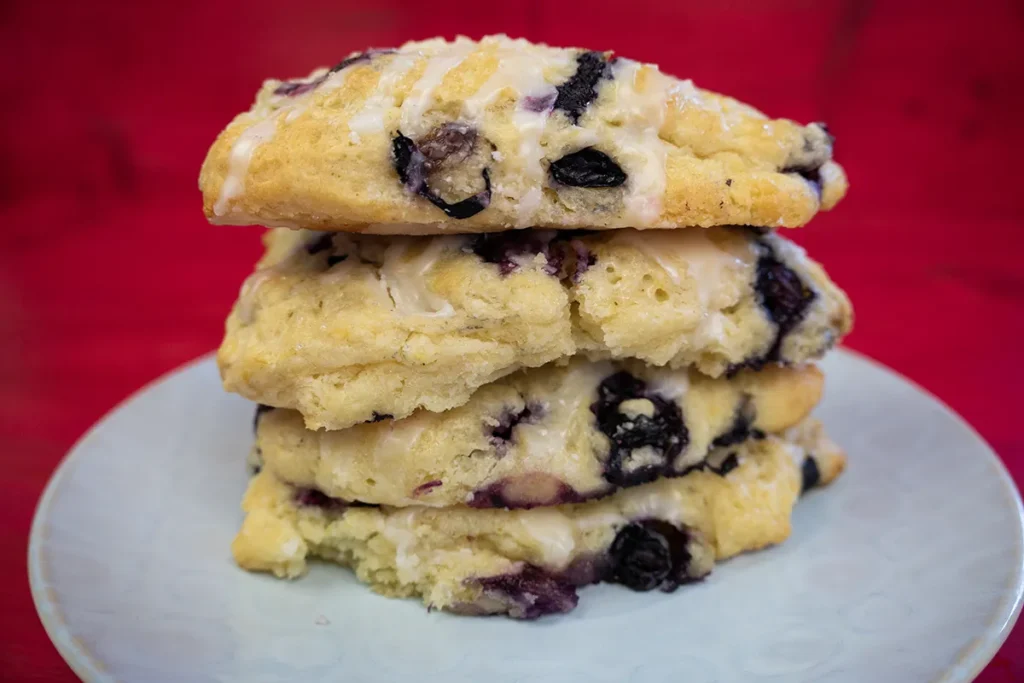 A stack of sourdough blueberry scones on a plate.