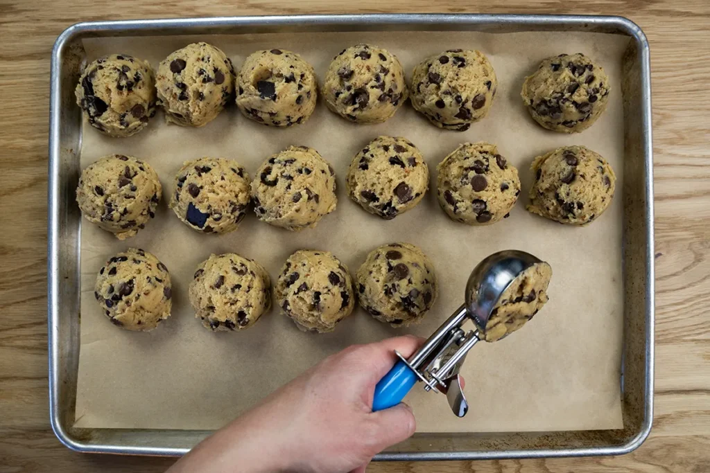 Scooping chocolate chip cookie dough.