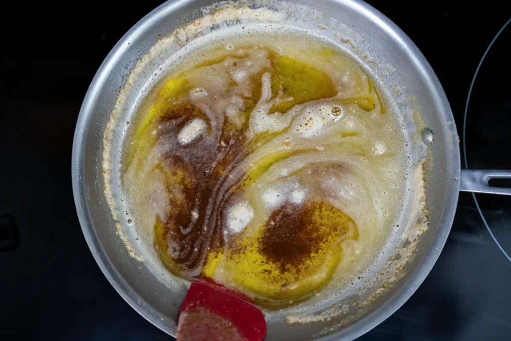 Browned butter in a stainless steel skillet.