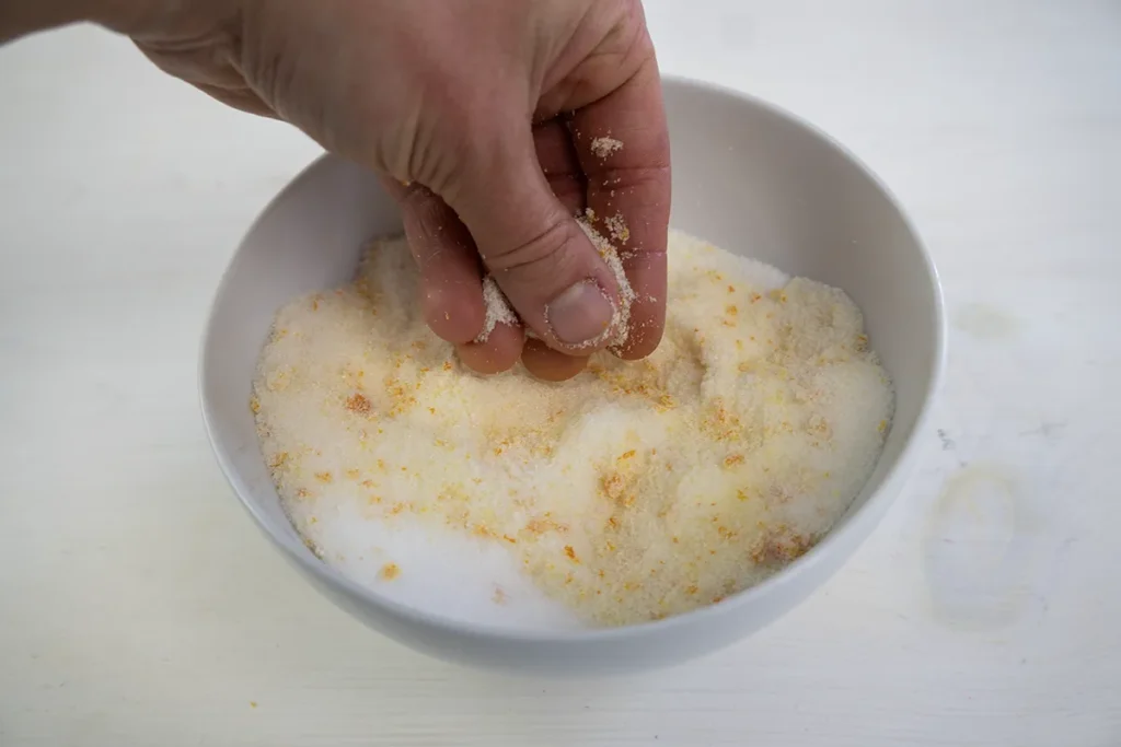 Rubbing orange zest into sugar.