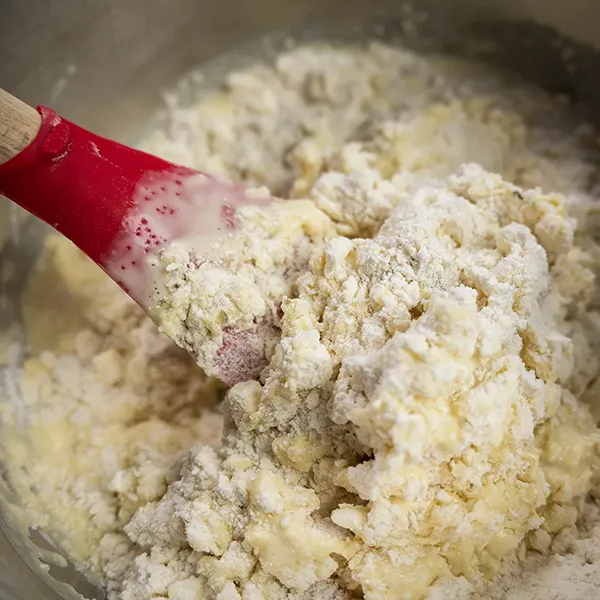 Adding the wet ingredients into scone dough.
