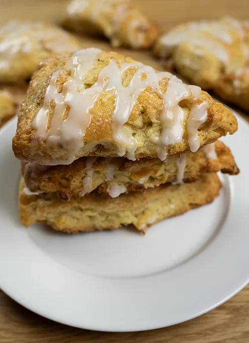 Stack of sourdough scones with apricot and white chocolate on a plate.