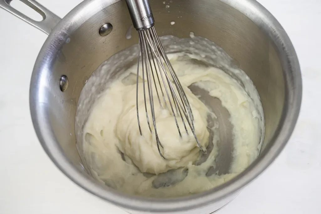Whisking tangzhong in a small saucepan.
