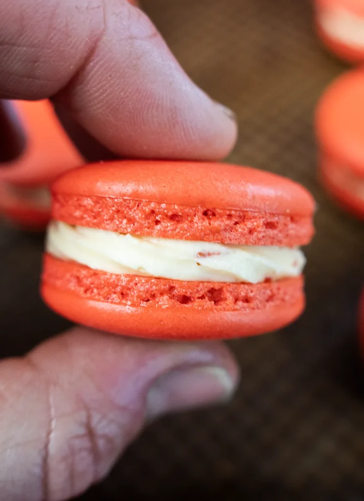 Sandwiching macarons together.