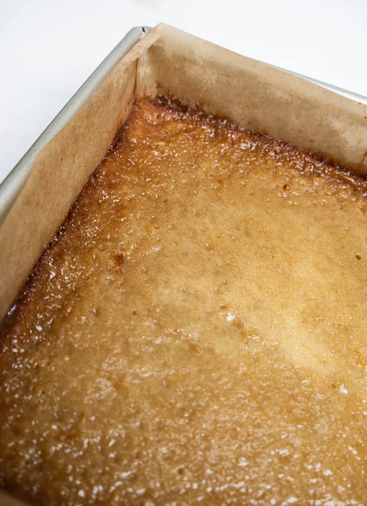 Baked slab of butter tart squares (uncut) fresh from the oven.