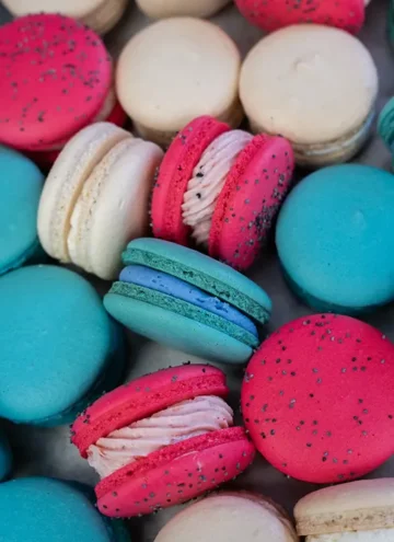 Overhead shot of pink, blue, and white macarons.