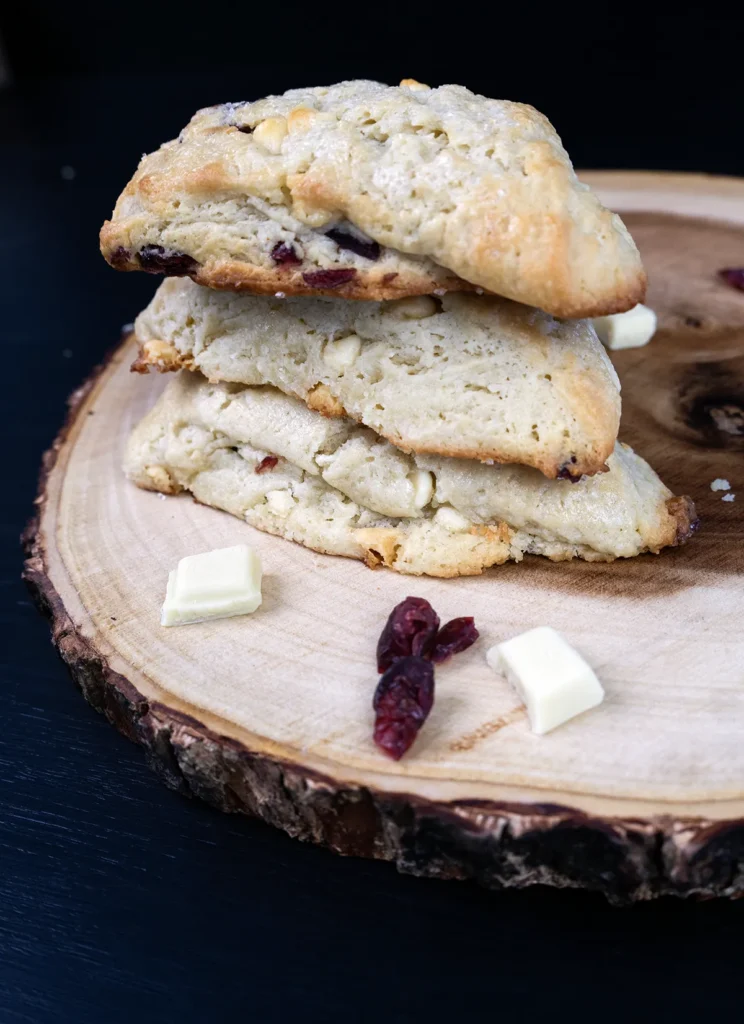Stack of scones on a wooden tray.