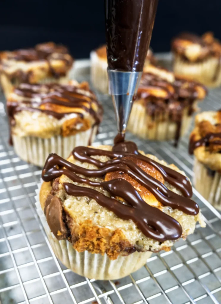 Piping chocolate ganache on a sourdough banana s'mores muffin.