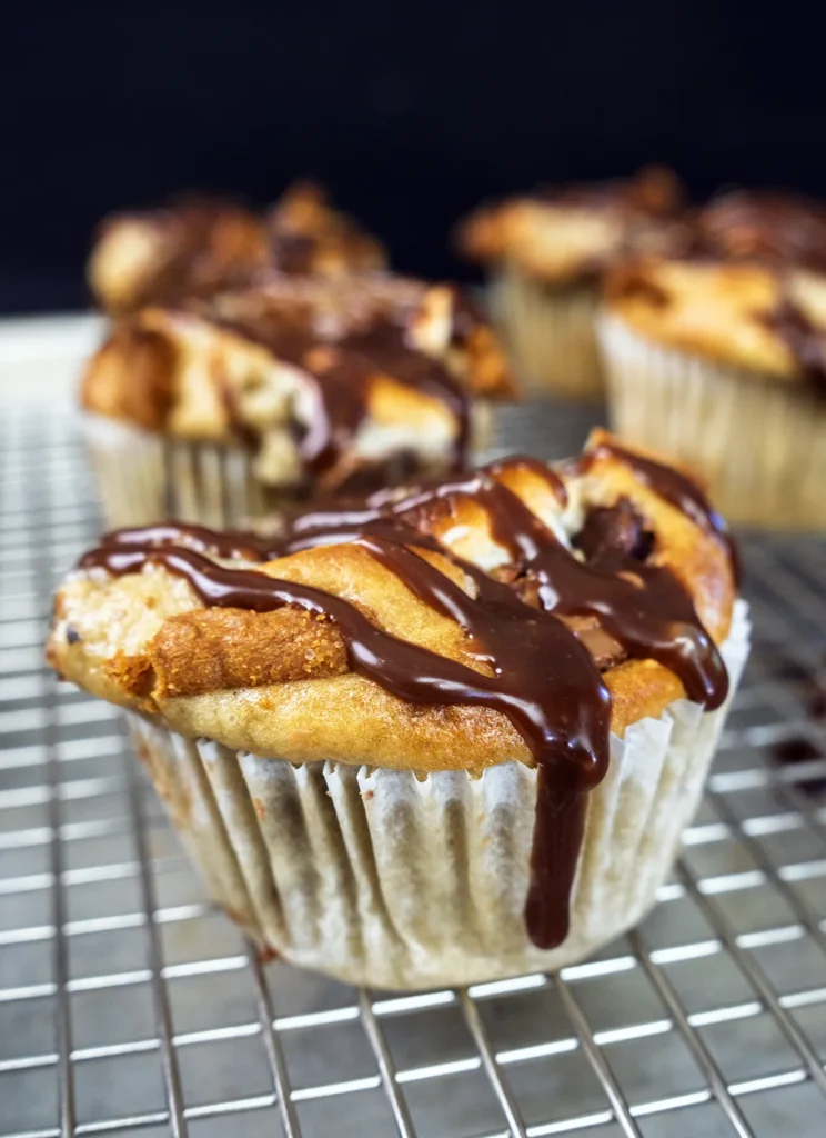 Chocolate ganache drizzles on a sourdough banana s'mores muffin.