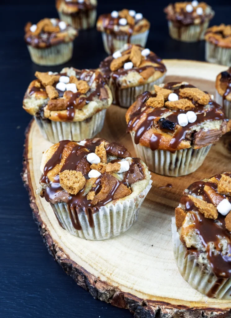 Sourdough banana s'mores muffins arranged on a wooden plate.