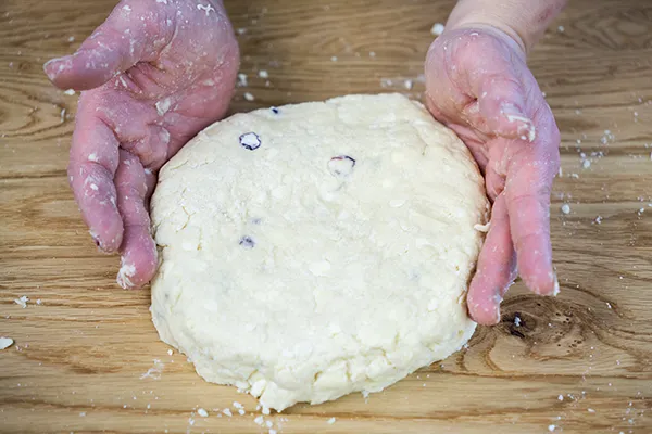 Patting scone dough into a circle.
