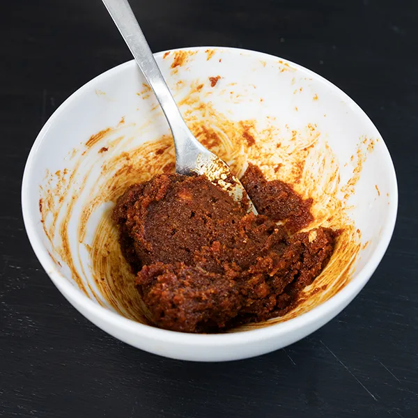 Mixing together butter, brown sugar, and gochujang to make gochujang caramel.