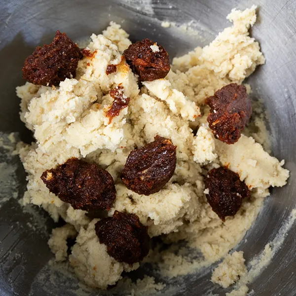 Dollops of gochujang caramel on sourdough sugar cookie dough.