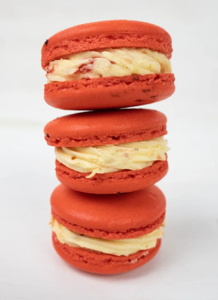 A stack of Strawberry Mango Tajín macarons.