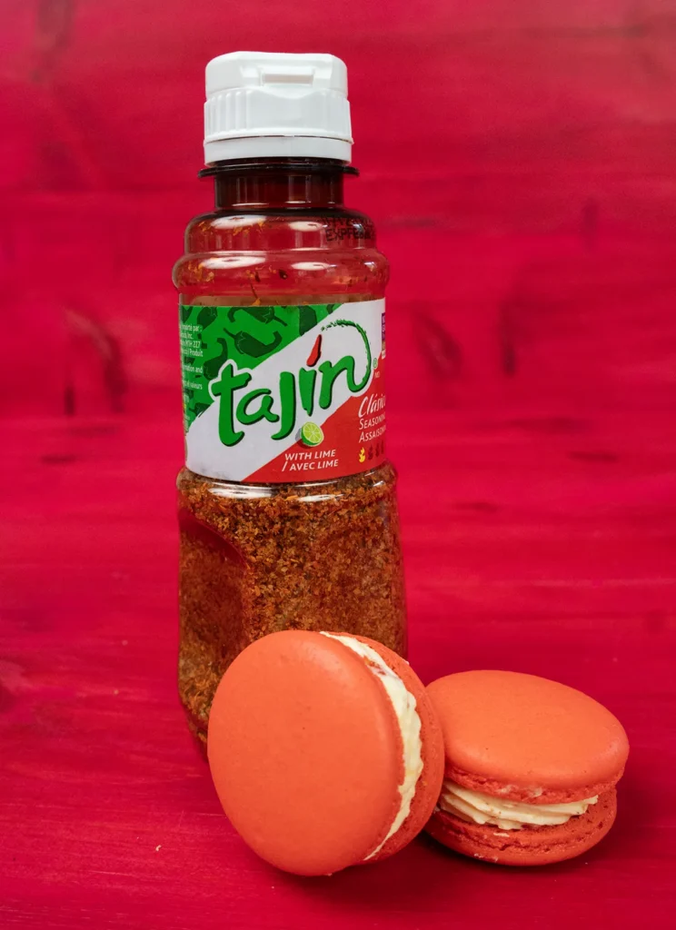 Strawberry Mango Tajín macarons with a bottle of Tajín seasoning.