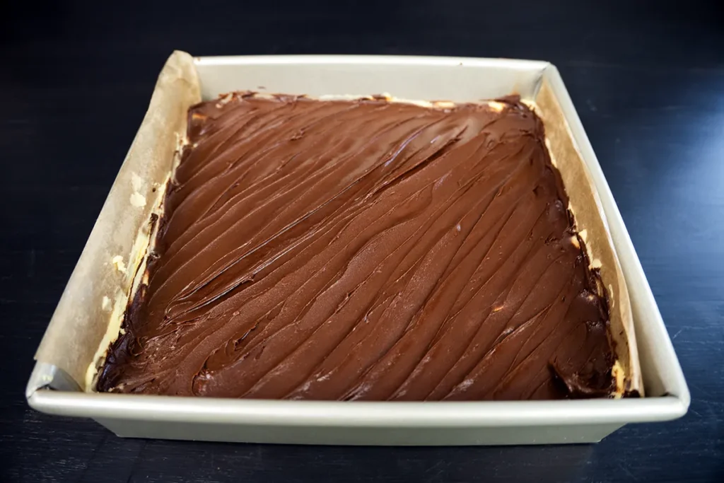The top layer of a Nanaimo bar, in a square pan.