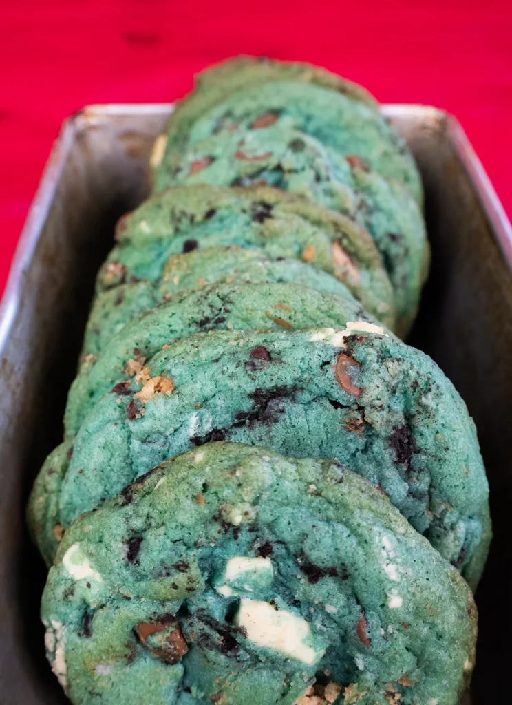 Blue cookie monster cookies arranged in a metal loaf pan.