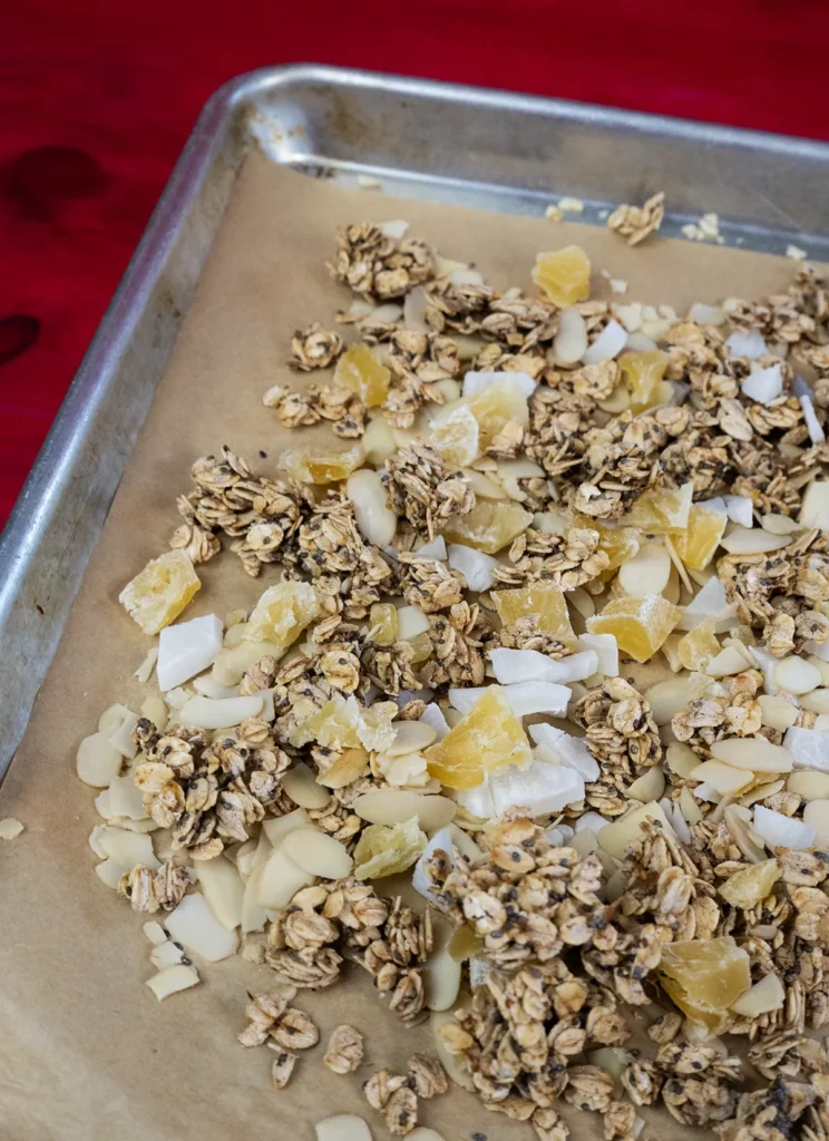 Sourdough granola spread out on a baking sheet.