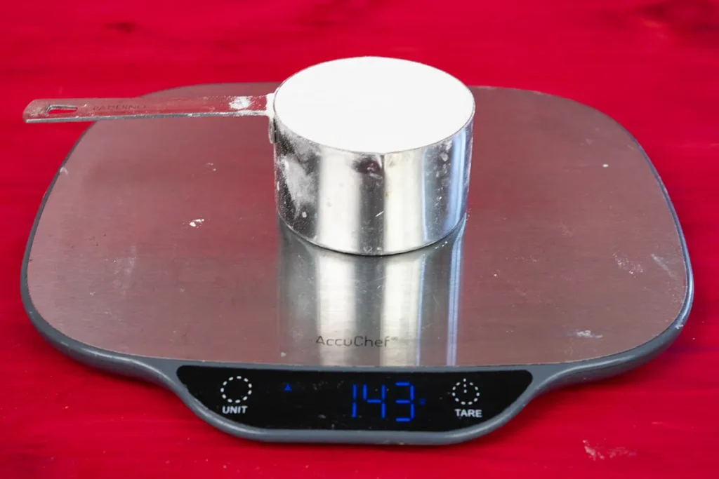 Seeing how much a cup of flour weighs.