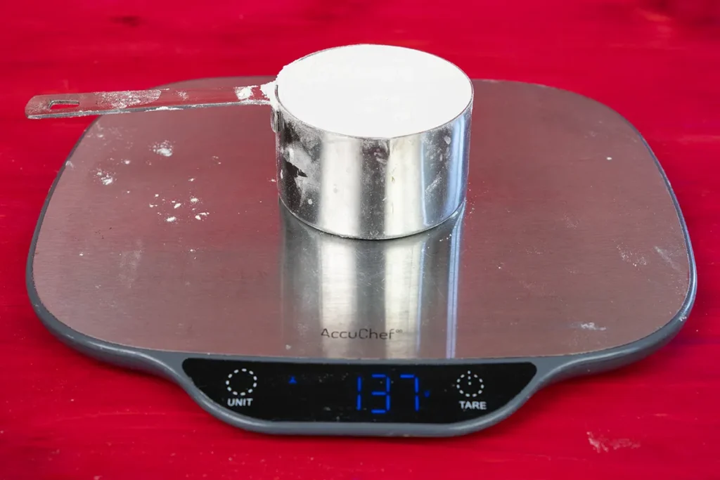 Seeing how much a cup of flour weighs.