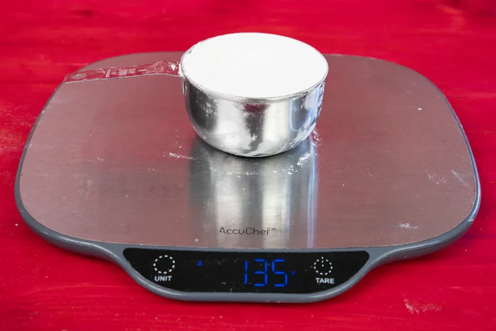 Seeing how much a cup of flour weighs.