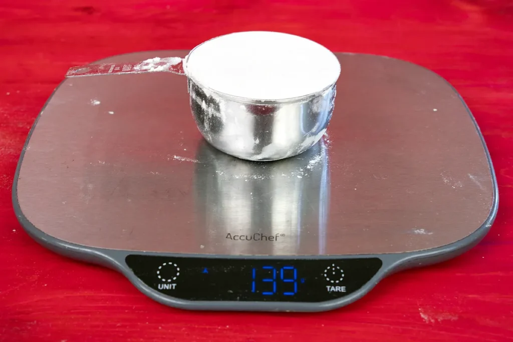 Seeing how much a cup of flour weighs.