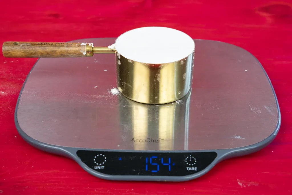 Seeing how much a cup of flour weighs.