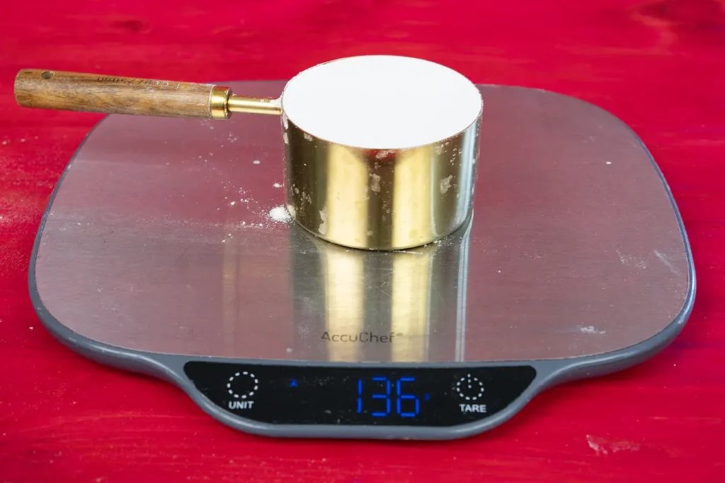 Seeing how much a cup of flour weighs.