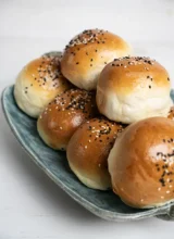 Ceramic tray with stacked homemade burger buns.